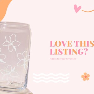 May include: Clear glass can-shaped drinking glass with white floral designs. The text "LOVE THIS LISTING?" is displayed in orange and pink, with the prompt "Add it to your favorites" below.