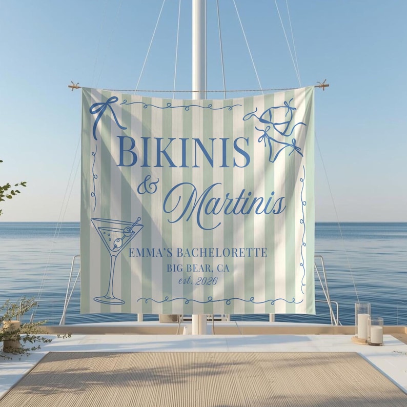 May include: A banner with the words "Bikinis & Martinis" in blue script, with a martini glass illustration. The banner has a light green and white striped background and includes the text "Emma's Bachelorette, Big Bear, CA, est. 2026".