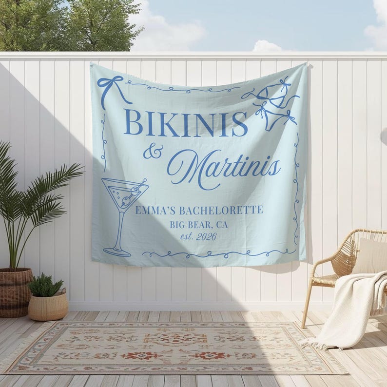 May include: A light blue banner with the words "Bikinis & Martinis" in dark blue script. The banner includes a martini glass illustration and the text "Emma's Bachelorette, Big Bear, CA est. 2026".