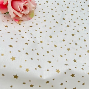 Golden stars on White. Cotton fabric. Wide fabric.