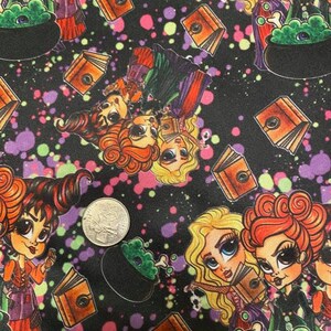 May include: A black fabric with a repeating pattern of witches, cauldrons, and books. The witches are wearing purple and green dresses and have large eyes. The cauldrons are green and have steam coming out of them. The books are brown and have a gold design on them. The background is black with colorful paint splatters.
