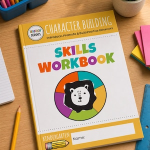 May include: A Skills Workbook for Kindergarten with the text "Character Building" and "Introduce, Promote & Build Positive Behaviors." The cover features a lion illustration within a colorful circle. A pencil and crayons are visible.