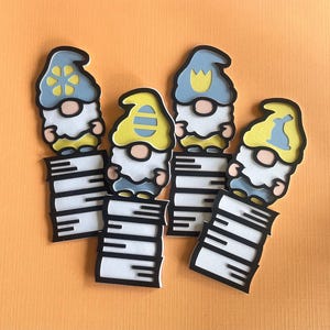 May include: Four whimsical gnome cutouts with blue and yellow hats, white beards, and black outlines. Each gnome stands atop a stack of white and black lines, possibly representing books. The background is a solid orange color.