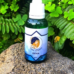 May include: A small green glass bottle with a white dropper top and a blue and white label that says "Tree Mystic Deva 30ml".