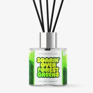 May include: A clear glass diffuser bottle with black reeds and a green and yellow label that reads "Soarin' Over Forest Greens" and "Soy Wax Candles".