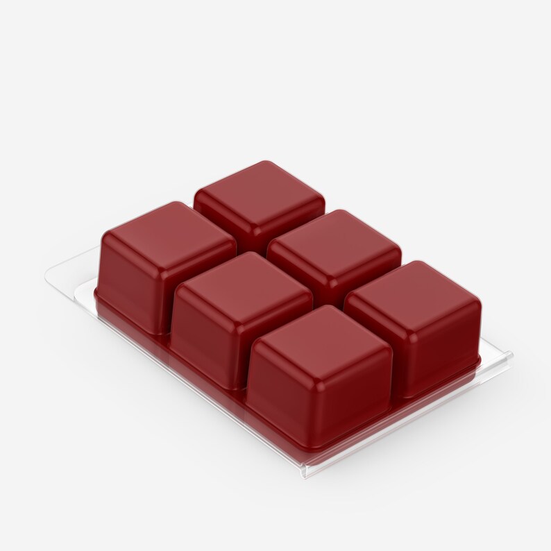 May include: A clear plastic tray filled with six red wax melts. The wax melts are square shaped and arranged in two rows of three.