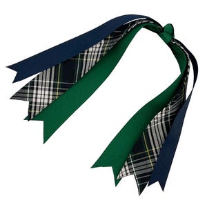 May include: A collection of decorative ribbons in navy blue, green, and plaid patterns. The ribbons are tied together at the top, with the ends cut into a pointed shape. The plaid ribbon features a mix of white, black, and yellow.