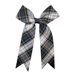 May include: A hair bow featuring a plaid pattern in shades of navy blue, forest green, white, and grey. The bow is constructed with two large top loops and two long, pointed tails, all secured in the center by a solid navy blue grosgrain ribbon knot.