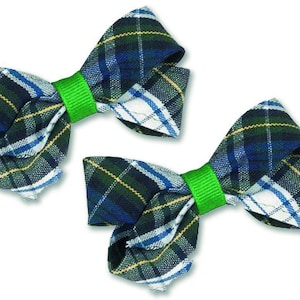May include: Two green, blue, and white plaid hair bows with green elastic bands.