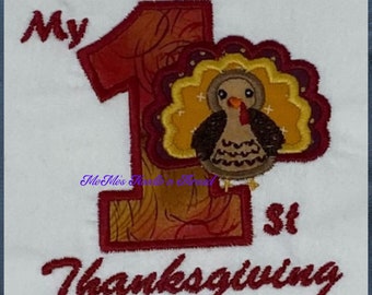 May include: Embroidered design of a red number one with a brown turkey inside. The text "My 1st Thanksgiving" is embroidered below the number.