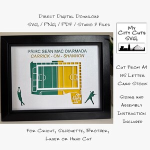 May include: Framed artwork featuring a green and yellow stadium design, with the text "PÁIRC SEAN MAC DIARMADA CARRICK-ON-SHANNON." Includes silhouettes of athletes. The frame is black.