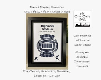 May include: A framed print featuring a navy blue stadium schematic labeled "Highmark Stadium, Orchard Park, NY." The image includes text: "Direct Digital Download," "My City Cuts SVG," and instructions for cutting and assembly. The frame is black.