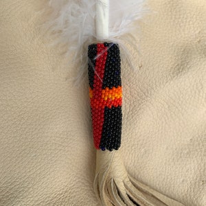 An Imitation Eagle Feather with beaded quill and fringe