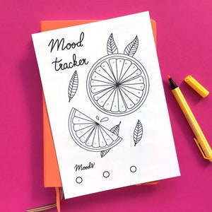 May include: A printable mood tracker with a black and white illustration of an orange slice. The text "Mood tracker" is written at the top of the page. There are three circles at the bottom of the page labeled "Moods".