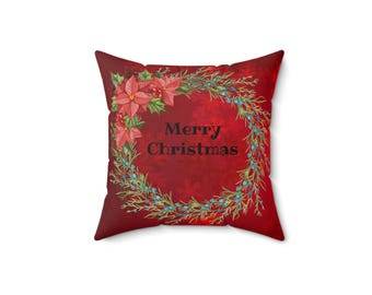 May include: Red throw pillow with a Christmas wreath design featuring poinsettia flowers and the text "Merry Christmas".