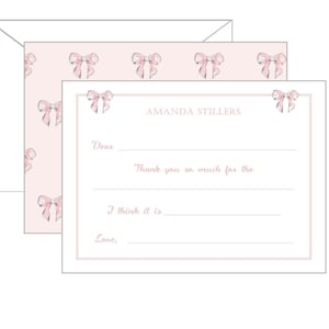 May include: A pink thank you card with a white border and a pattern of pink bows. The card has the text "Amanda Stillers" at the top and the text "Dear", "Thank you so much for the", "I think it is", and "Love," printed on the card.