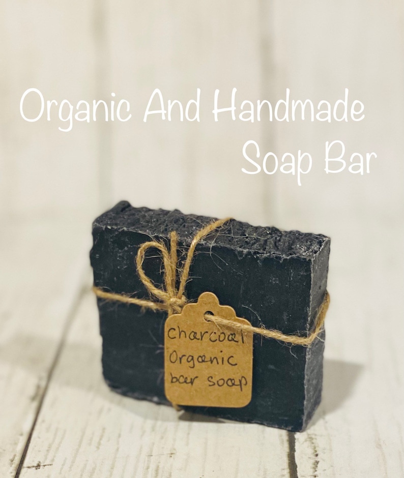 Pu&ograve; includere: Un sapone organico al carbone di legna nero, legato con uno spago e un'etichetta di carta marrone su cui &egrave; scritto "charcoal organic bar soap".