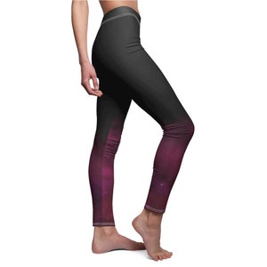 May include: Black leggings with a gradient design that fades from black to a deep purple with a galaxy-like pattern. The leggings have a high waist and white stitching along the waistband and ankles. The fabric appears to be smooth and form-fitting.