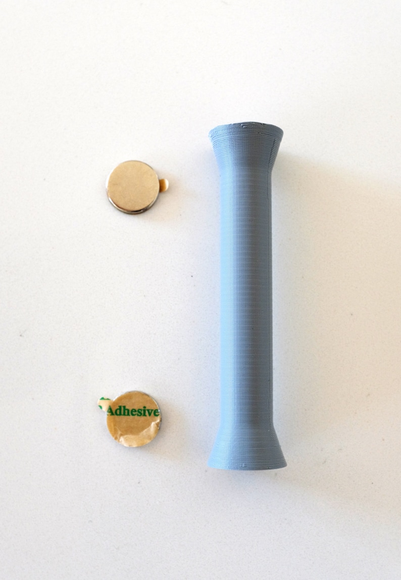 May include: Two round adhesive backed metal discs and a light blue plastic tube.
