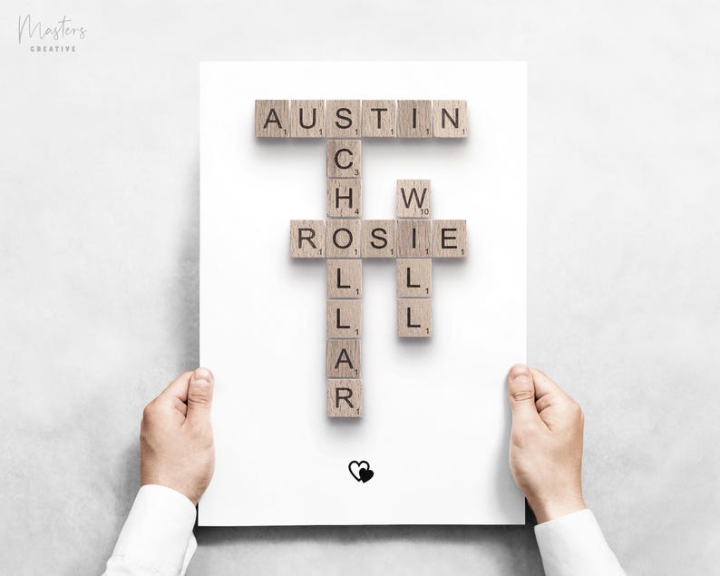 May include: A white rectangular print featuring wooden letter tiles arranged in a crossword style. The names Austin, Rosie, and Will are connected by the word Schollar. A small black heart icon is positioned at the bottom center of the page.