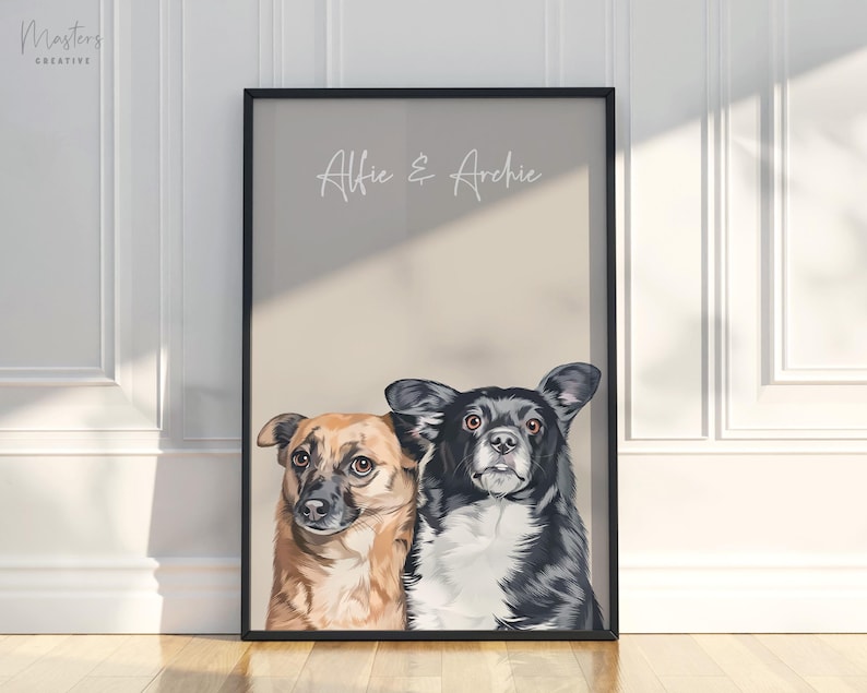 May include: Framed portrait featuring two dogs, one brown and tan, the other black and white. The artwork is set against a neutral background with the names "Alfie & Archie" in script. The frame is black, and the artwork is leaning against a wall.