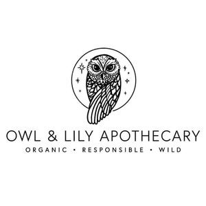 May include: Black and white logo for Owl & Lily Apothecary. The logo features a stylized owl with its wings spread, inside a circle with stars. The text "Owl & Lily Apothecary" is below the owl, with the words "Organic, Responsible, Wild" below the text.