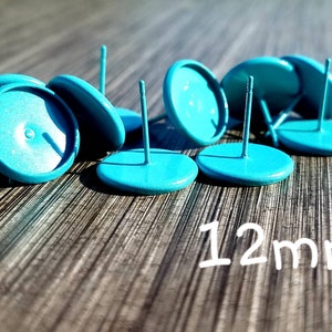 May include: A group of 12mm turquoise blue earring settings with posts. The settings are round and have a smooth finish.