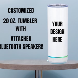 May include: White 20 oz. tumbler with a built-in Bluetooth speaker. The tumbler has a blank space where you can add your own design. "YOUR DESIGN HERE" is written on the tumbler.