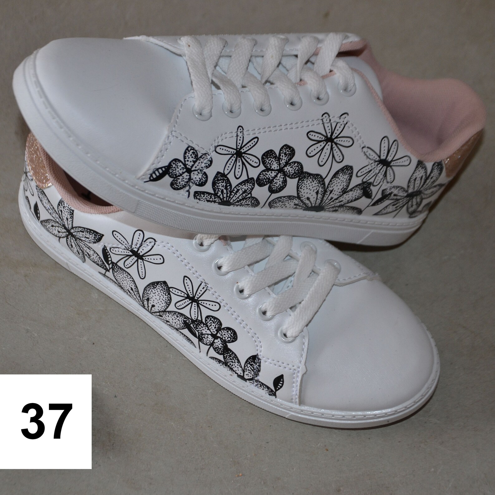 white sneakers with flowers on them