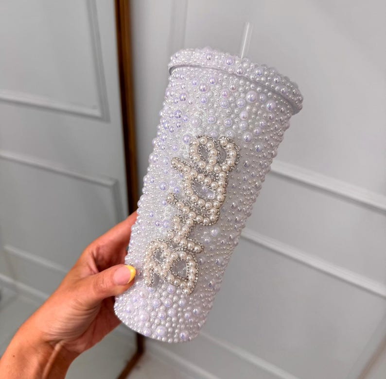 WOW! The ultimate cool-girl hen party accessory is here! Get hen party ready and prepare to sparkle with our dazzling BRIDE pearl stanley cup! Featuring a twist top, straw, pearl detailing and silver diamante bride text, this personalised cup is definitely one to make the bride stand out!