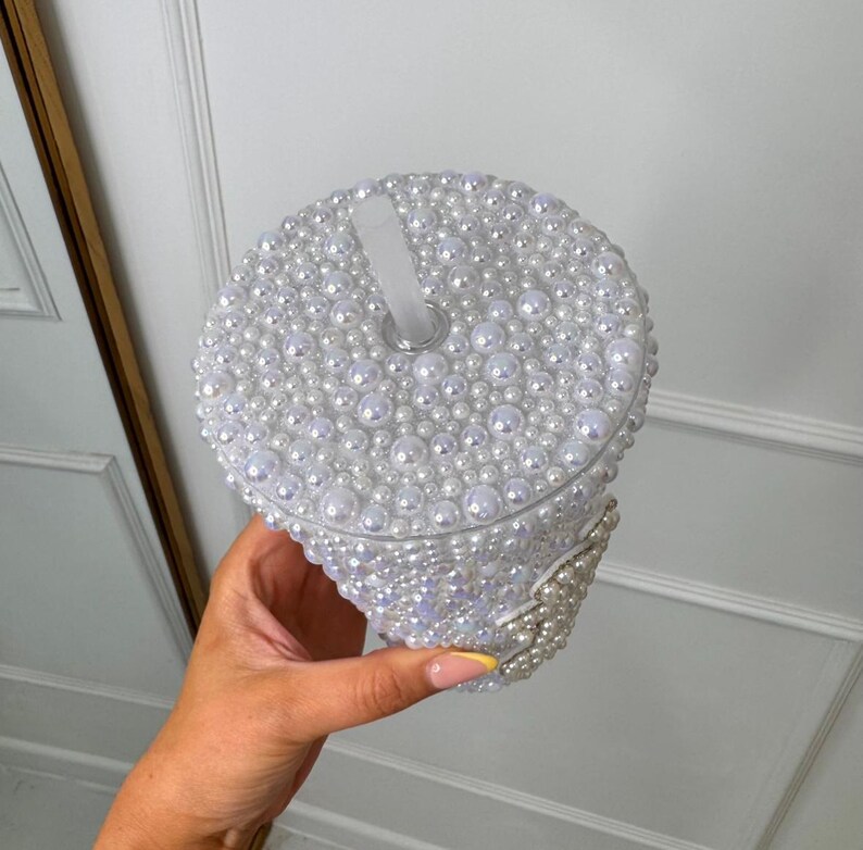 WOW! The ultimate cool-girl hen party accessory is here! Get hen party ready and prepare to sparkle with our dazzling BRIDE pearl stanley cup! Featuring a twist top, straw, pearl detailing and silver diamante bride text, this personalised cup is definitely one to make the bride stand out!