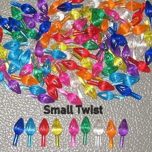 May include: Assortment of small twist Christmas light bulbs in various colors, including red, green, blue, yellow, purple, and clear. The bulbs are arranged in a pile on a silver surface. The text "Small Twist" is printed below the bulbs.