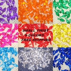 May include: Assortment of 9 colors of small twist Christmas light bulbs. The colors are purple, orange, green, pink, red, yellow, blue, clear, and blue.  SMALL TWIST 9 COLORS FREE SHIPPING