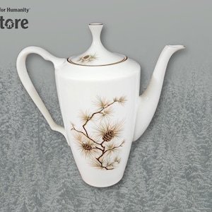 May include: White ceramic teapot with a pine tree design. The teapot has a gold trim around the lid and spout.
