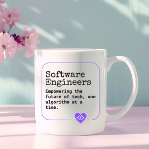 May include: White ceramic mug with a black and white graphic that reads "Software Engineers Empowering the future of tech, one algorithm at a time."  The graphic is surrounded by a purple border and includes a purple heart with the code symbol "</>" inside.