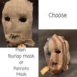 May include: Two burlap masks are displayed. One is plain, the other is painted with a patriotic design of red, white, and blue stripes and stars. The masks have eye and mouth openings.
