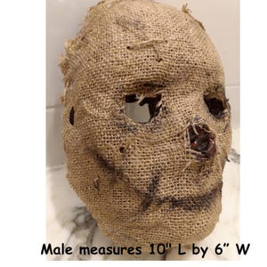 Puede incluir: Una m&aacute;scara de arpillera con aberturas para ojos y boca. La m&aacute;scara es de color beige con detalles en marr&oacute;n oscuro y mide 25 cm de largo por 15 cm de ancho. La m&aacute;scara tiene un dise&ntilde;o cosido y es adecuada para Halloween.
