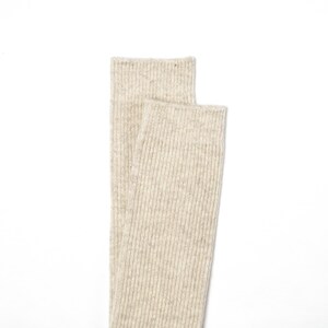 May include: A pair of beige ribbed socks. The socks are made of a soft, comfortable material and are perfect for everyday wear.