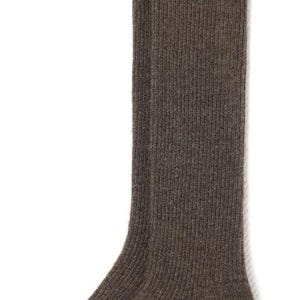 May include: A pair of brown knee-high socks made of a soft, fuzzy material. The socks have a ribbed texture.