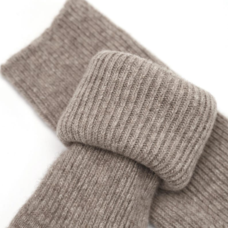 May include: A pair of brown ribbed socks made of soft, cozy material. The socks are folded over, showing the ribbed texture.