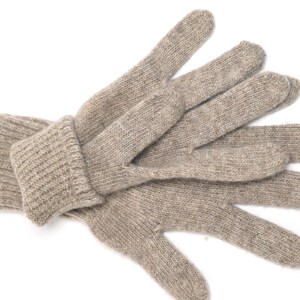 May include: A pair of beige knitted gloves with a ribbed cuff. The gloves are made of a soft, warm material and are perfect for keeping your hands warm in cold weather.