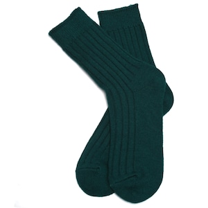 May include: A pair of dark green ribbed socks made of wool.