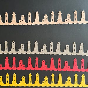 May include: Paper cut-out lighthouse borders in shades of tan, gray, red, and yellow. Each border features a row of lighthouses atop a stylized wave design. The lighthouses are evenly spaced and have detailed cut-out windows and structures. The background is black.