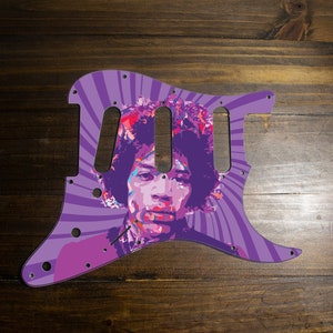 May include: Purple guitar pickguard with a psychedelic swirl design featuring a portrait of Jimi Hendrix.