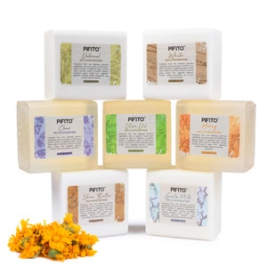 May include: A set of ten melt and pour soap bases in various colors and scents, including oatmeal, white, clear, olive oil, honey, shea butter, and goat's milk. Each bar features a unique design and text label with the brand name "PIFITO".