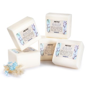 May include: Four white bars of goat's milk melt and pour soap base. The bars are stacked on top of each other. The label on the bars reads "PIFITO Goats Milk Melt & Pour Soap Base".