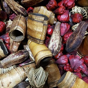 May include: A mix of dried natural elements, including brown and tan bark, woven straw, and red dried flowers. These natural elements are often used in potpourri or decorative arrangements.