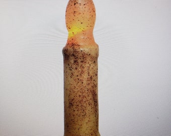 May include: A tall, candle-shaped light fixture with a flame-like top. The fixture has a yellow and orange gradient, with brown speckles. The base is a darker yellow. The overall design mimics a traditional candle.