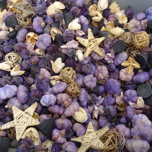 May include: A mix of potpourri with purple, brown, and beige elements. The potpourri includes dried flowers, star-shaped wicker, and small round wicker balls.