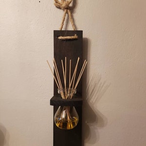 Stained black wood diffuser holder set. Includes wood holder, diffuser oil, and a set of diffuser reeds.